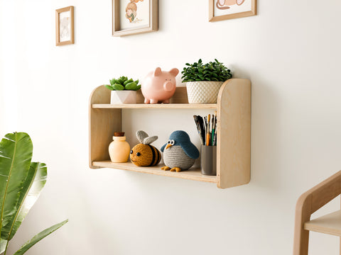 Close-up of a minimalist wooden wall shelf with two spacious levels, mounted on the wall and designed for kids' toys and everyday items in a clean, modern interior