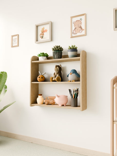 Montessori wall-mounted shelf in a nursery, holding toys, plants, and art supplies, with a minimalist and natural design.